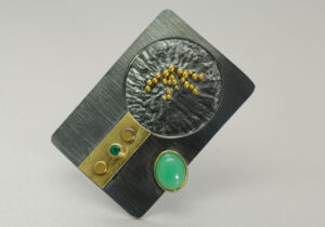BRPN–2: Oxidized reticulated silver, 22k, 18k gold, tsavorite, chrysoprase. Brooch may be worn as a pendant. 1.75 inches long by 1.25 inches wide. SOLD