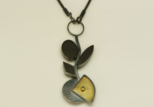 NKL-4- Oxidized silver, 18k gold on silver, 14k gold, peridot black onyx, 18 inch chain, pendant 3.50 inches by 1.50 inches.